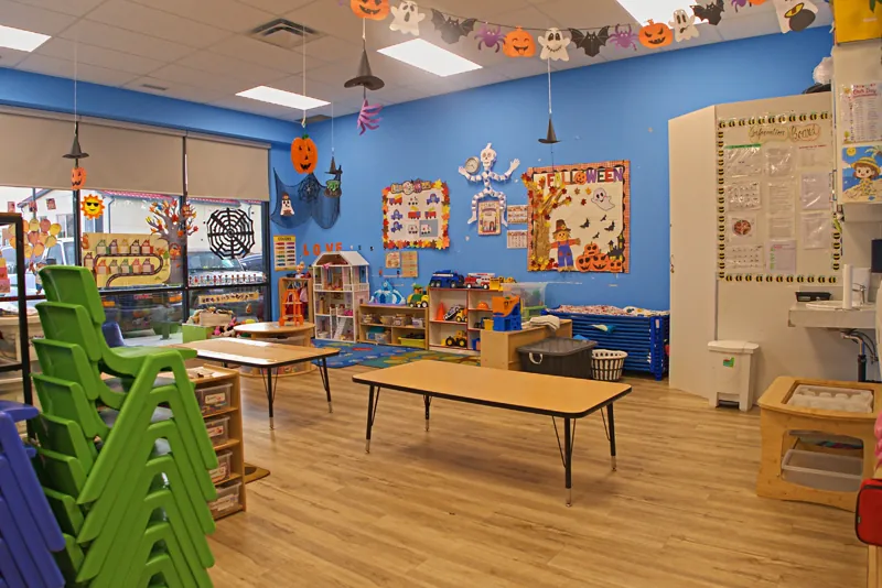 Blue room with big windows and play shelves