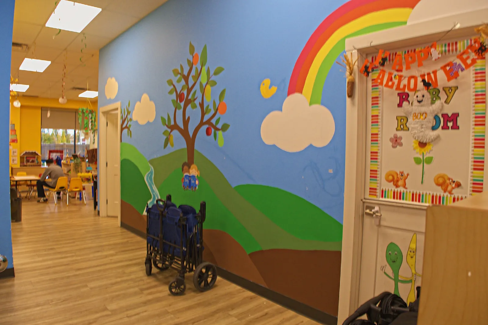 Our baby room sits behind the rainbow mural, a calm space just for our youngest.
