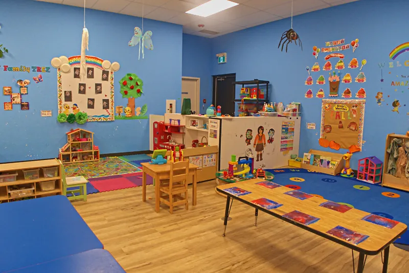 Blue room with reading rug and child-height tables