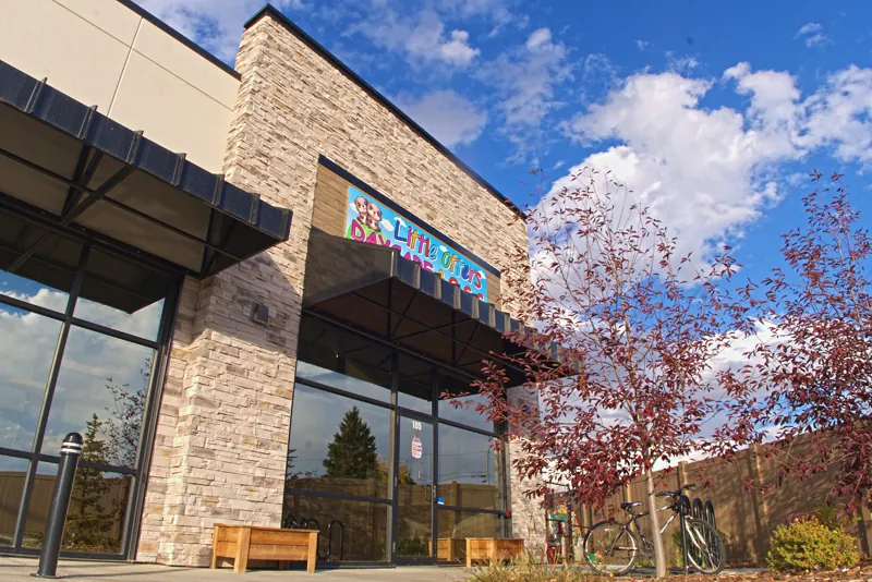 The Little Otters building with its rainbow sign under a blue sky